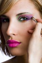 Attractive woman applying eyeshadow Royalty Free Stock Photo