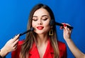 Attractive woman applying makeup brush. Perfect skin tone. Stunning beauty. Looking good and feeling confident Royalty Free Stock Photo