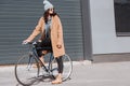 attractive woman in autumn outfit and black sunglasses sitting on bicycle Royalty Free Stock Photo