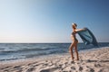 Attractive woman with beach towel and straw hat on sand near sea, space for text Royalty Free Stock Photo