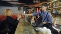 Attractive woman being served cocktails at the bar. Bartender making cocktail to guest. Royalty Free Stock Photo