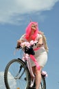 portrait of attractive woman with bike in demon costume