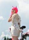 portrait of attractive woman with bike in demon costume