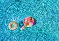 Woman floats over blue pool water Royalty Free Stock Photo