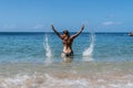 Attractive woman in bikini playing in water, Woman sending water over her head