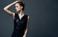 Attractive woman black dress glamor cosmetics luxury dark background Royalty Free Stock Photo