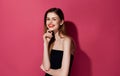 Attractive woman black dress makeup fashion smile pink background Royalty Free Stock Photo
