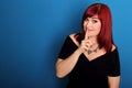 Attractive woman in black dress, red hair making gesture silence Royalty Free Stock Photo