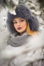 Attractive woman with black fur cap and gray shawl enjoying the winter. Frontal view of fashionable brunette girl with makeup Royalty Free Stock Photo