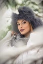 Attractive woman with black fur cap and gray shawl enjoying the winter. Frontal view of fashionable brunette girl with makeup Royalty Free Stock Photo