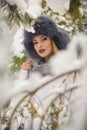 Attractive woman with black fur cap and gray shawl enjoying the winter. Frontal view of fashionable brunette girl with makeup Royalty Free Stock Photo