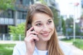 Attractive woman with blond hair laughing at phone Royalty Free Stock Photo