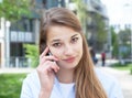 Attractive woman with blond hair listening at phone Royalty Free Stock Photo