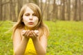 Attractive woman blowing kiss in spring nature Royalty Free Stock Photo