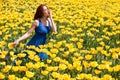 Attractive woman in blue dress in beautiful flower field Royalty Free Stock Photo
