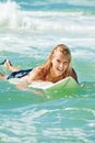 Attractive woman bodyboards on surfboard Royalty Free Stock Photo