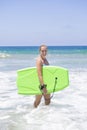 Attractive woman boogie boarding in the ocean waves Royalty Free Stock Photo