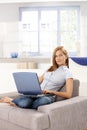 Attractive woman browsing internet at home