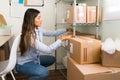 Female entrepreneur preparing to ship packages