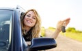 An attractive woman in a car holds a car key in her hand. Royalty Free Stock Photo