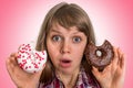 Attractive woman is choosing between two donuts Royalty Free Stock Photo