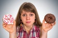 Attractive woman is choosing between two donuts Royalty Free Stock Photo