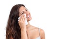 Attractive woman cleaning her face with a tissue