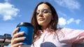 Attractive woman with coffee paper cup enjoying loneliness, solitude before work