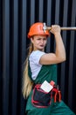 Attractive woman in coverall with tools posing on abstract background Royalty Free Stock Photo