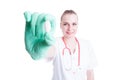 Attractive woman doctor smiling and holding a pill in close-up Royalty Free Stock Photo