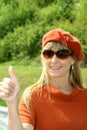 Attractive woman, dressed in orange, thumbs up, Royalty Free Stock Photo