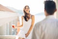 Attractive woman drinking cocktail and enjoying her summer vacation.Drinking refreshing drink and smiling to a man