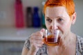 Attractive woman drinking tea. In thought, the gaze is directed somewhere in the distance Royalty Free Stock Photo