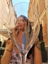 Attractive woman drinking white wine outdoors in a bar on the street, summer, italy Royalty Free Stock Photo