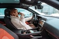 Attractive woman driver nsitting behind the steering wheel in her car Royalty Free Stock Photo