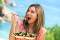 Attractive woman eating green salad. Royalty Free Stock Photo