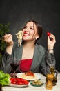 Attractive woman eating italian pasta spaghetti in restaurant