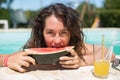 Attractive woman eating watermelon in pool Royalty Free Stock Photo