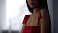 Attractive woman in elegant red dress flirting on date, sexual desire, seduction
