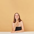 Attractive woman enjoying facial massage. Satisfied woman with perfect skin care. Caucasian girl wearing black top using jade Royalty Free Stock Photo