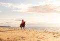 Attractive woman enjoying a leisurely ride on the back of a white horse along a sandy beach Royalty Free Stock Photo