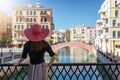 Woman enjoys the view to the Venice like Qanat Quartier on the Pearl in Doha Royalty Free Stock Photo