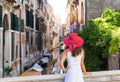 Attractive woman enjoys the view towards a canal in Venice Royalty Free Stock Photo