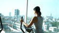 Attractive woman exercising on a stair stepper.