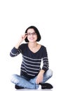 Attractive woman in eyeglasses sitting crossed-legs.