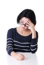 Attractive woman in eyeglasses sitting by table. Royalty Free Stock Photo