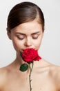 Attractive woman eyes closed sniffing a rose red lips