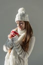 attractive woman in fashionable winter sweater and scarf holding cup of tea isolated Royalty Free Stock Photo