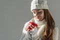 attractive woman in fashionable winter sweater and scarf holding cup of tea isolated Royalty Free Stock Photo