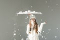 attractive woman in fashionable winter sweater and scarf standing under japanese umbrella, snow falling isolated Royalty Free Stock Photo